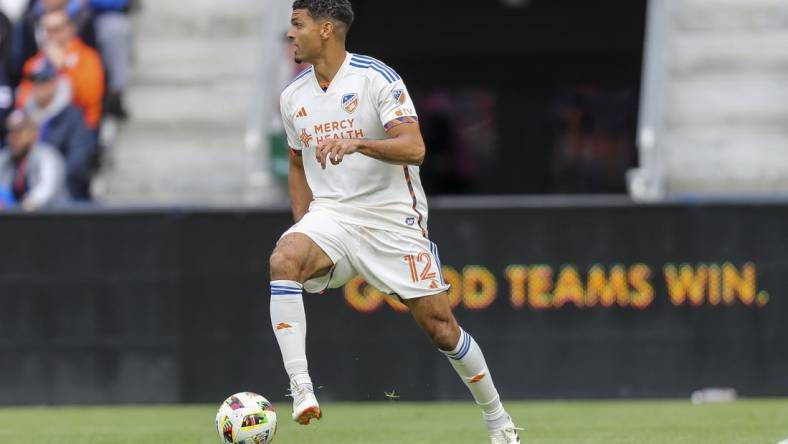 Feb 25, 2024; Cincinnati, Ohio, USA; FC Cincinnati defender Miles Robinson (12) dribbles against Toronto FC in the first half at TQL Stadium. Mandatory Credit: Katie Stratman-USA TODAY Sports