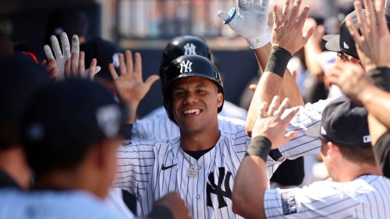 Feb 25, 2024; Tampa, Florida, USA; New York Yankees left fielder Juan Soto (22) celebrates in the dugout after he scores during the third inning against the Toronto Blue Jays at George M. Steinbrenner Field. Mandatory Credit: Kim Klement Neitzel-USA TODAY Sports