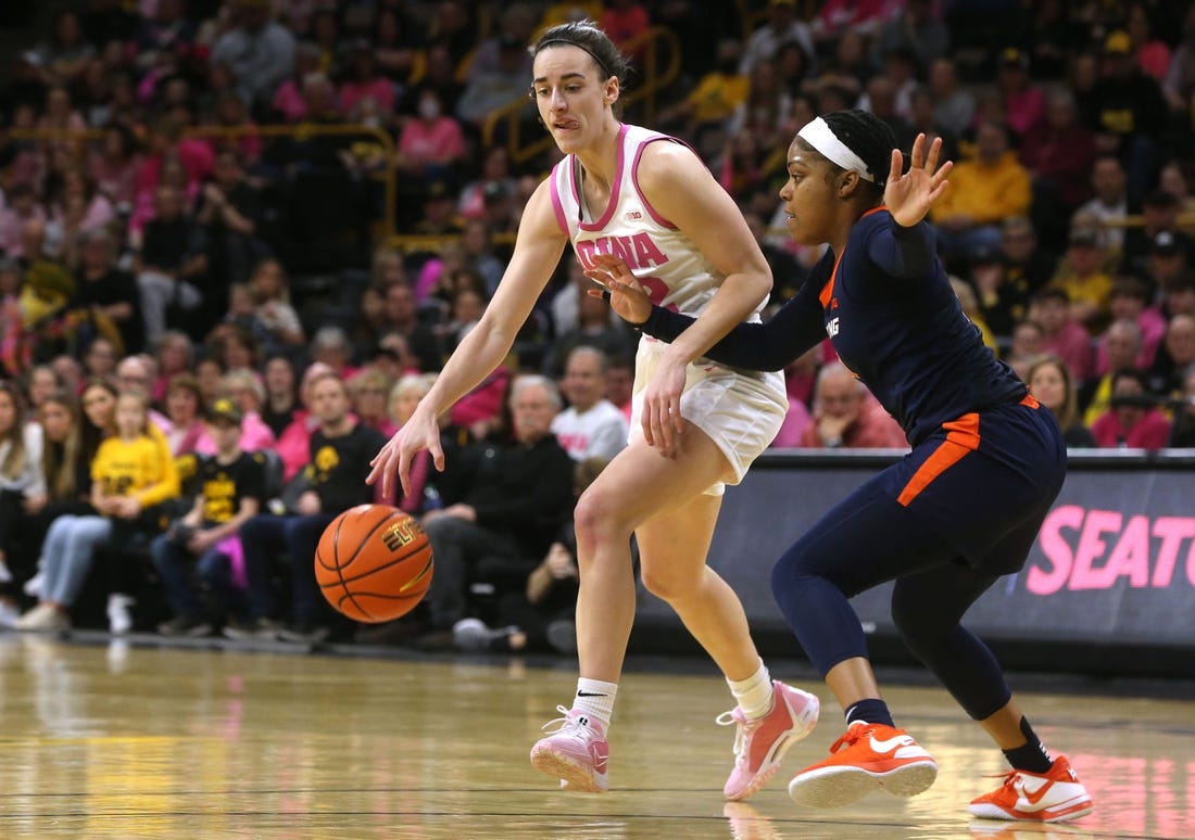 Iowa's Caitlin Clark (22) dribbles as Illinois   s Makira Cook (3) defends Saturday, Feb. 24, 2024 at Carver-Hawkeye Arena.