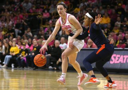 Iowa's Caitlin Clark (22) dribbles as Illinois   s Makira Cook (3) defends Saturday, Feb. 24, 2024 at Carver-Hawkeye Arena.