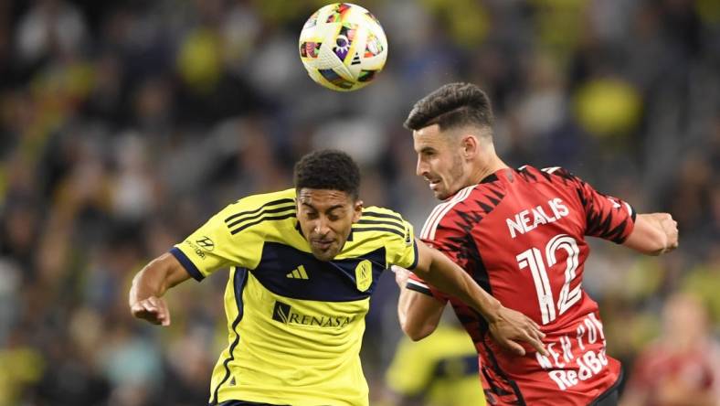 Feb 25, 2024; Nashville, Tennessee, USA; Nashville SC forward McKinze Gaines (17) goes up for a header against New York Red Bulls defender Dylan Nealis (12) at Geodis Park. Mandatory Credit: Steve Roberts-USA TODAY Sports