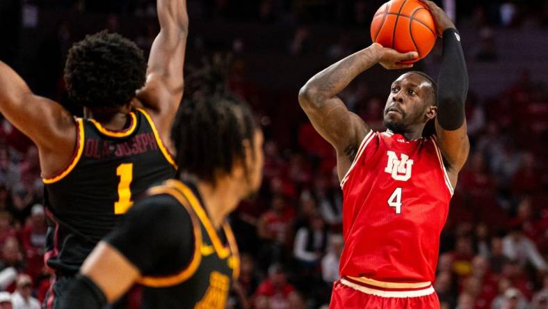 Feb 25, 2024; Lincoln, Nebraska, USA; Nebraska Cornhuskers forward Juwan Gary (4) shoots the ball against Minnesota Golden Gophers forward Joshua Ola-Joseph (1) and guard Elijah Hawkins (0) during the first half at Pinnacle Bank Arena. Mandatory Credit: Dylan Widger-USA TODAY Sports