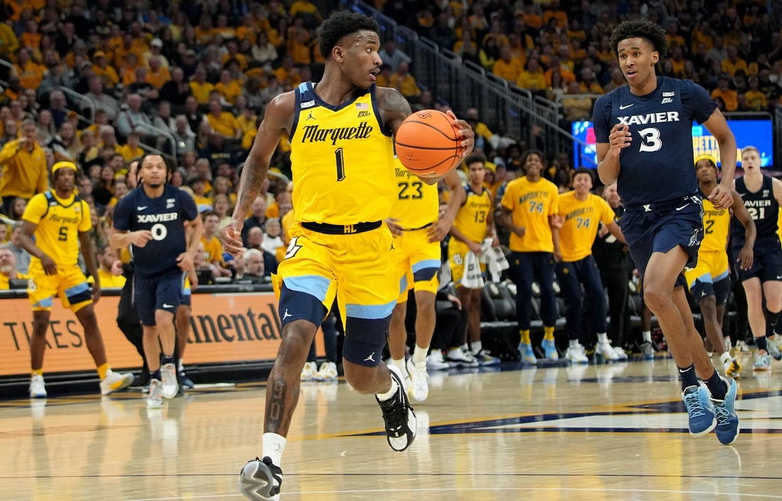 Marquette guard Kam Jones (1) scores on a fast break during the first half of their game against Xavier Sunday, February 25, 2023 at Fiserv Forum in Milwaukee, Wisconsin.