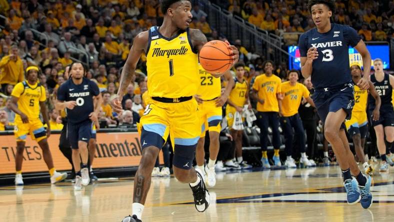 Marquette guard Kam Jones (1) scores on a fast break during the first half of their game against Xavier Sunday, February 25, 2023 at Fiserv Forum in Milwaukee, Wisconsin.