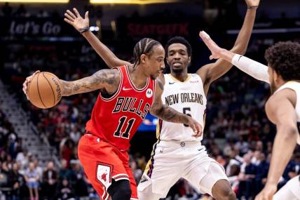Feb 25, 2024; New Orleans, Louisiana, USA;  Chicago Bulls forward DeMar DeRozan (11) looks to pass the ball against New Orleans Pelicans forward Herbert Jones (5) during the second half at Smoothie King Center. Mandatory Credit: Stephen Lew-USA TODAY Sports