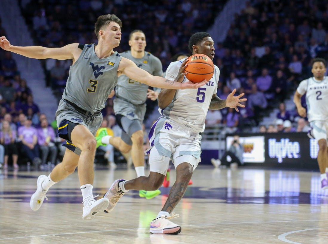 Feb 26, 2024; Manhattan, Kansas, USA; West Virginia Mountaineers guard Kerr Kriisa (3) knocks the ball away from Kansas State Wildcats guard Cam Carter (5) during the first half at Bramlage Coliseum. Mandatory Credit: Scott Sewell-USA TODAY Sports