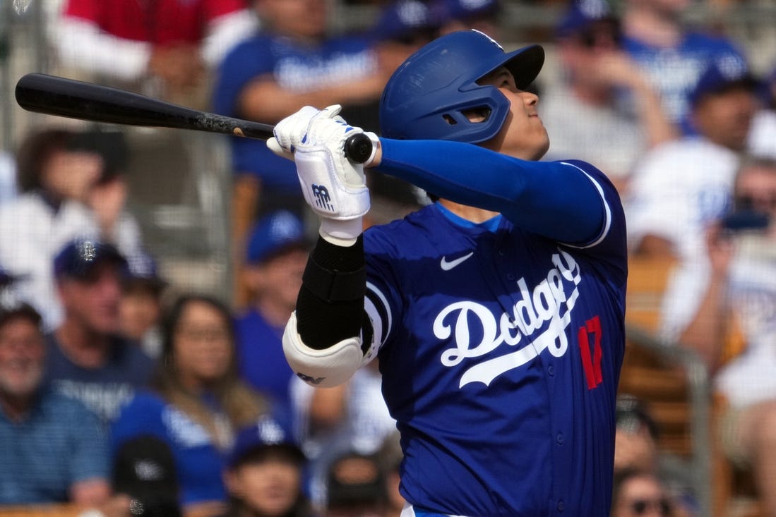 Feb 27, 2024; Phoenix, Arizona, USA; Los Angeles Dodgers designated hitter Shohei Ohtani (17) hits a two run home run during the fifth inning against the Chicago White Sox at Camelback Ranch-Glendale. Mandatory Credit: Joe Camporeale-USA TODAY Sports