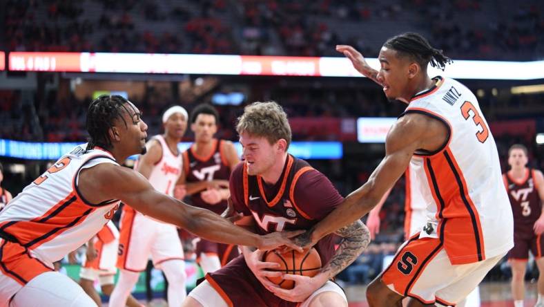 Feb 27, 2024; Syracuse, New York, USA; Virginia Tech Hokies guard Tyler Nickel is pressed between Syracuse Orange guard JJ Starling (2) and guard Judah Mintz (3) in the first half at the JMA Wireless Dome. Mandatory Credit: Mark Konezny-USA TODAY Sports