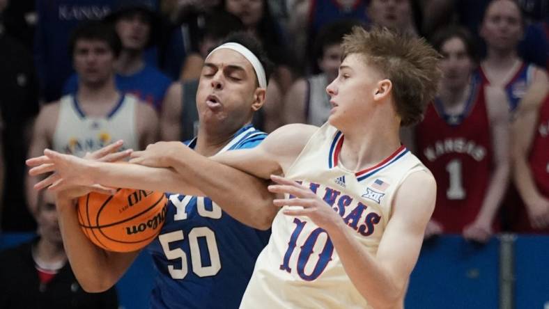 Feb 27, 2024; Lawrence, Kansas, USA; Brigham Young Cougars center Aly Khalifa (50) and Kansas Jayhawks guard Johnny Furphy (10) fight for a loose ball during the first half at Allen Fieldhouse. Mandatory Credit: Denny Medley-USA TODAY Sports