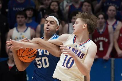 Feb 27, 2024; Lawrence, Kansas, USA; Brigham Young Cougars center Aly Khalifa (50) and Kansas Jayhawks guard Johnny Furphy (10) fight for a loose ball during the first half at Allen Fieldhouse. Mandatory Credit: Denny Medley-USA TODAY Sports