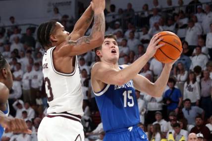 Feb 27, 2024; Starkville, Mississippi, USA; Kentucky Wildcats guard Reed Sheppard (15) drives to the basket as Mississippi State Bulldogs guard Shakeel Moore (3) defends during the second half at Humphrey Coliseum. Mandatory Credit: Petre Thomas-USA TODAY Sports
