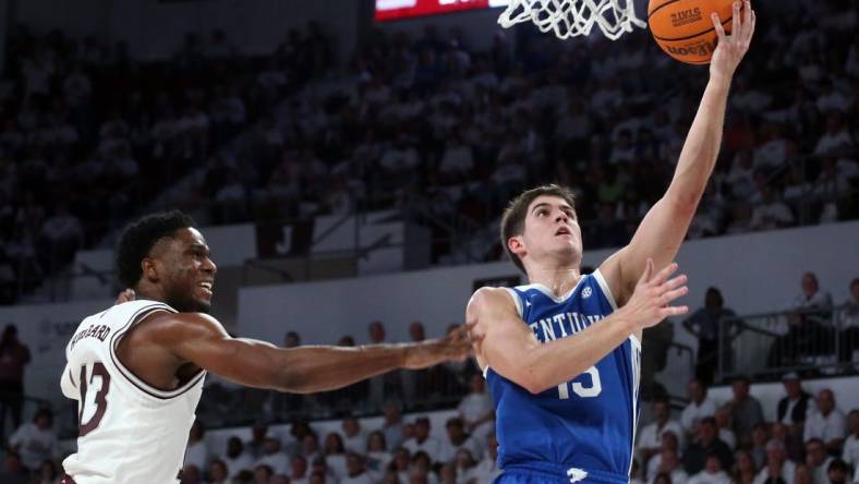 Feb 27, 2024; Starkville, Mississippi, USA; Kentucky Wildcats guard Reed Sheppard (15) drives to the basket as Mississippi State Bulldogs guard Josh Hubbard (13) defends during the second half at Humphrey Coliseum. Mandatory Credit: Petre Thomas-USA TODAY Sports