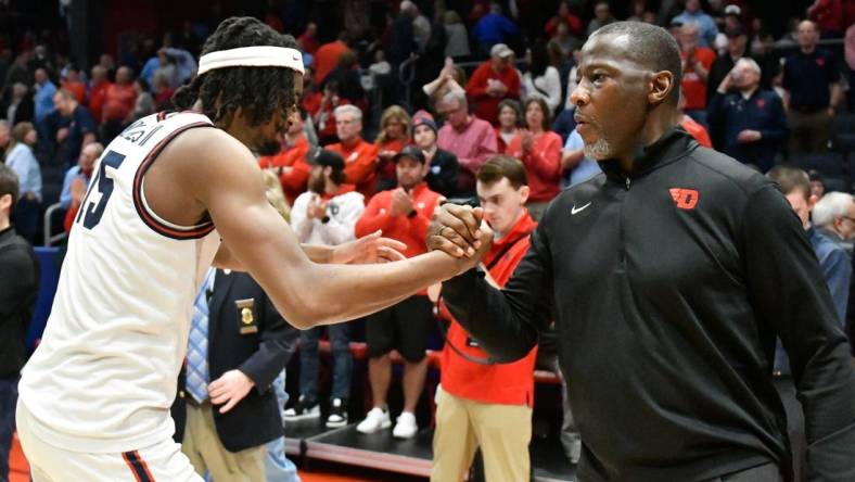 Feb 27, 2024; Dayton, Ohio, USA;  Dayton Flyers forward DaRon Holmes II (15) and head coach Anthony Grant shakes hands after the game against Davidson Wildcats at University of Dayton Arena. Mandatory Credit: Matt Lunsford-USA TODAY Sports