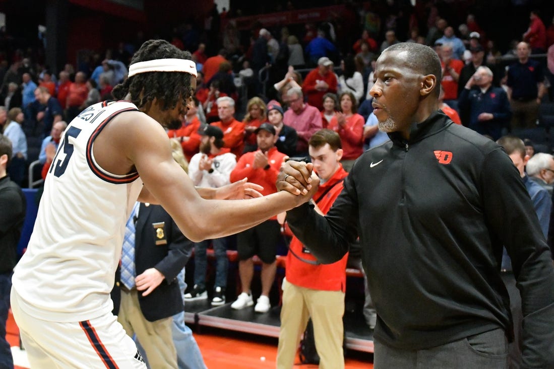 Feb 27, 2024; Dayton, Ohio, USA;  Dayton Flyers forward DaRon Holmes II (15) and head coach Anthony Grant shakes hands after the game against Davidson Wildcats at University of Dayton Arena. Mandatory Credit: Matt Lunsford-USA TODAY Sports