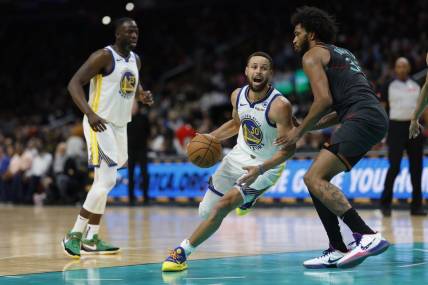Feb 27, 2024; Washington, District of Columbia, USA; Golden State Warriors guard Stephen Curry (30) drives to the basket as Washington Wizards forward Marvin Bagley III (35) defends in the second half at Capital One Arena. Mandatory Credit: Geoff Burke-USA TODAY Sports