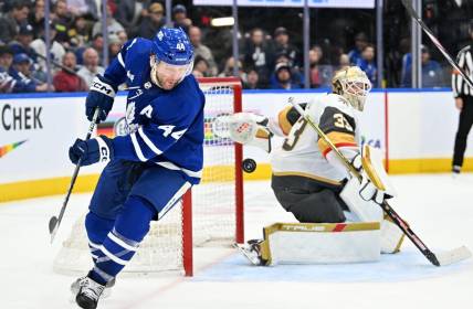 Feb 27, 2024; Toronto, Ontario, CAN;  Toronto Maple Leafs defenseman Morgan Rielly (44) chases the puck after a save and rebound from Vegas Golden Knights goalie Adin Hill (33) in the third period at Scotiabank Arena. Mandatory Credit: Dan Hamilton-USA TODAY Sports