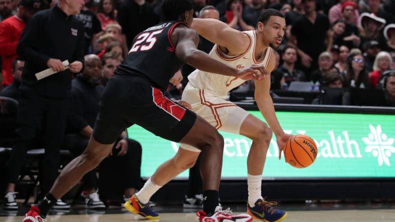 Feb 27, 2024; Lubbock, Texas, USA;  UT Longhorns forward Dylan Disu (1) dribbles the ball against Texas Tech Red Raiders forward Robert Jennings (25) in the first half  at United Supermarkets Arena. Mandatory Credit: Michael C. Johnson-USA TODAY Sports