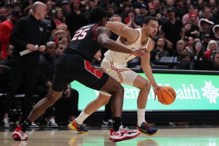 Feb 27, 2024; Lubbock, Texas, USA;  UT Longhorns forward Dylan Disu (1) dribbles the ball against Texas Tech Red Raiders forward Robert Jennings (25) in the first half  at United Supermarkets Arena. Mandatory Credit: Michael C. Johnson-USA TODAY Sports