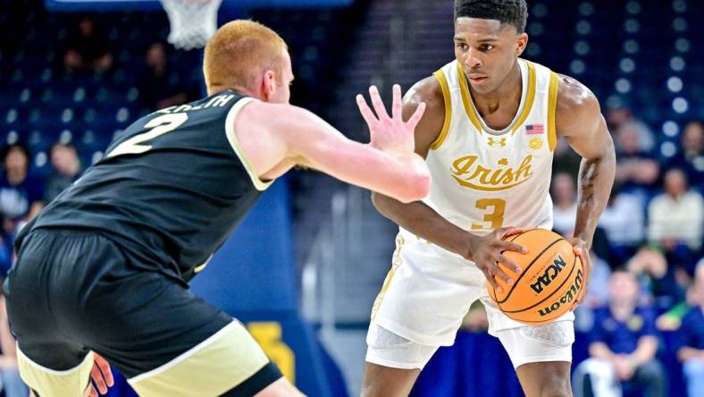 Feb 27, 2024; South Bend, Indiana, USA; Notre Dame Fighting Irish guard Markus Burton (3) holds the ball as Wake Forest Demon Deacons guard Cameron Hildreth (2) defends in the first half at the Purcell Pavilion. Mandatory Credit: Matt Cashore-USA TODAY Sports