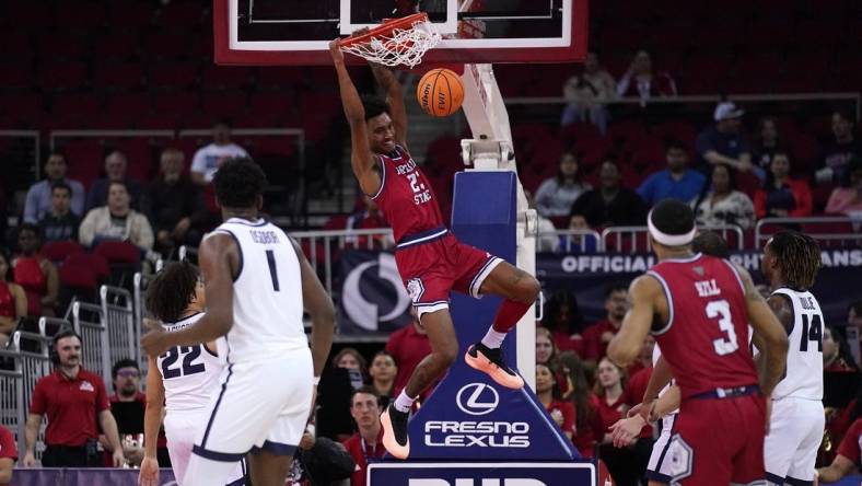 Feb 27, 2024; Fresno, California, USA; Fresno State Bulldogs guard Leo Colimerio (23) dunks the ball against the Utah State Aggies in the first half at the Save Mart Center. Mandatory Credit: Cary Edmondson-USA TODAY Sports