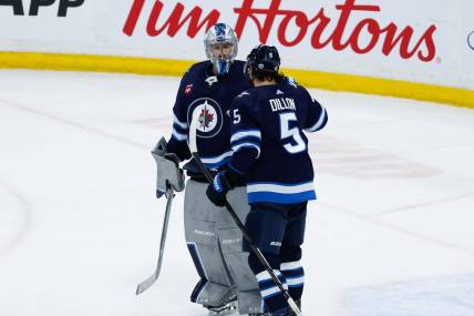Feb 27, 2024; Winnipeg, Manitoba, CAN; Winnipeg Jets goalie Laurent Boissoit (39) is congratulated by Winnipeg Jets defenseman Brenden Dillon (5) on his win against the St. Louis Blues at the end of the third period at Canada Life Centre. Mandatory Credit: Terrence Lee-USA TODAY Sports