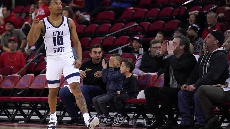 Feb 27, 2024; Fresno, California, USA; Utah State Aggies guard Darius Brown II (10) reacts after making a three point shot against the Fresno State Bulldogs with under two second remaining in the second half at the Save Mart Center. Mandatory Credit: Cary Edmondson-USA TODAY Sports