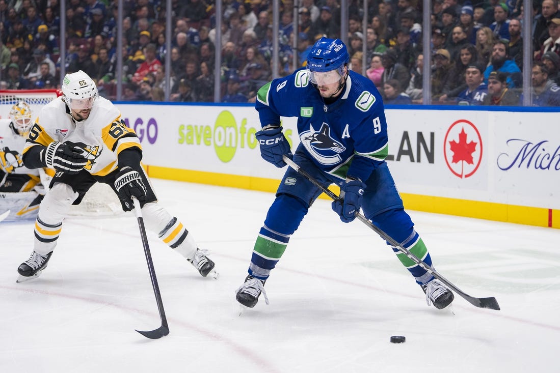 Feb 27, 2024; Vancouver, British Columbia, CAN; Pittsburgh Penguins defenseman Erik Karlsson (65) defends against Vancouver Canucks forward J.T. Miller (9) in the third period at Rogers Arena. Penguins won 4-3 in overtime. Mandatory Credit: Bob Frid-USA TODAY Sports