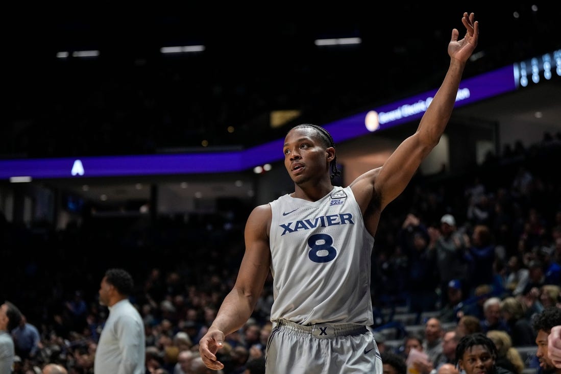 Xavier Musketeers guard Quincy Olivari (8) waves to the crowd as they applaud his 2001st career point scored in the first half of the NCAA Big East conference basketball game between the Xavier Musketeers and the DePaul Blue Demons at the Cintas Center in Cincinnati on Wednesday, Feb. 28, 2024.