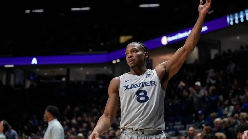 Xavier Musketeers guard Quincy Olivari (8) waves to the crowd as they applaud his 2001st career point scored in the first half of the NCAA Big East conference basketball game between the Xavier Musketeers and the DePaul Blue Demons at the Cintas Center in Cincinnati on Wednesday, Feb. 28, 2024.