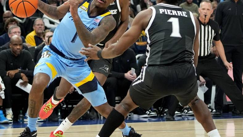 Feb 28, 2024; Milwaukee, Wisconsin, USA; Marquette guard Kam Jones (1) makes a move on Providence guard Jayden Pierre (1) during the first half of their game at Fiserv Forum. Mandatory Credit: Mark Hoffman/Milwaukee Journal Sentinel-USA TODAY Sports