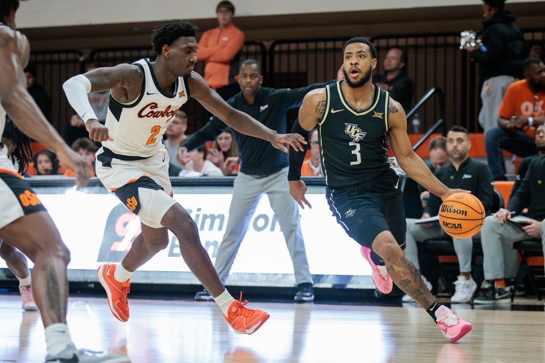 Feb 28, 2024; Stillwater, Oklahoma, USA; UCF Knights guard Darius Johnson (3) drives to the basket around Oklahoma State Cowboys forward Eric Dailey Jr. (2) during the first half at Gallagher-Iba Arena. Mandatory Credit: William Purnell-USA TODAY Sports