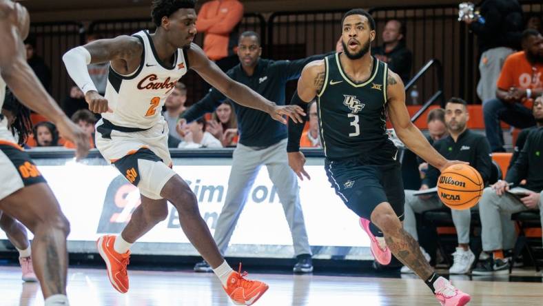 Feb 28, 2024; Stillwater, Oklahoma, USA; UCF Knights guard Darius Johnson (3) drives to the basket around Oklahoma State Cowboys forward Eric Dailey Jr. (2) during the first half at Gallagher-Iba Arena. Mandatory Credit: William Purnell-USA TODAY Sports