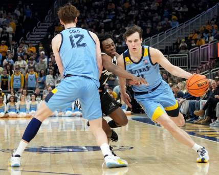 Marquette guard Tyler Kolek (11) takes advantage of a pick by forward Ben Gold (12) on guard Jayden Pierre (1) during the first half of their game Wednesday, February 28, 2024 at Fiserv Forum in Milwaukee, Wisconsin.