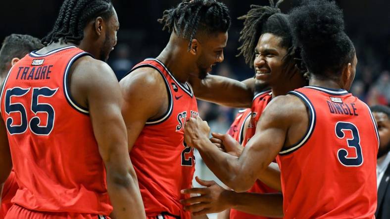 Feb 28, 2024; Indianapolis, Indiana, USA; St. John's Red Storm forward Zuby Ejiofor (24) and St. John's Red Storm forward Glenn Taylor Jr. (35) celebrate during a timeout against the Butler Bulldogs during the first half at Hinkle Fieldhouse. Mandatory Credit: Robert Goddin-USA TODAY Sports