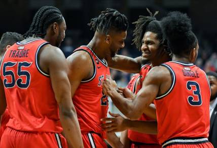 Feb 28, 2024; Indianapolis, Indiana, USA; St. John's Red Storm forward Zuby Ejiofor (24) and St. John's Red Storm forward Glenn Taylor Jr. (35) celebrate during a timeout against the Butler Bulldogs during the first half at Hinkle Fieldhouse. Mandatory Credit: Robert Goddin-USA TODAY Sports