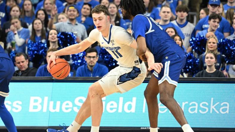 Feb 28, 2024; Omaha, Nebraska, USA; Creighton Bluejays center Ryan Kalkbrenner (11) drives against Seton Hall Pirates center Jaden Bediako (15) in the first half at CHI Health Center Omaha. Mandatory Credit: Steven Branscombe-USA TODAY Sports