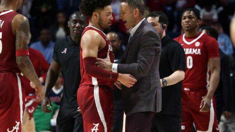 Feb 28, 2024; Oxford, Mississippi, USA; Alabama Crimson Tide head coach Nate Oats (right) embraces Alabama Crimson Tide guard Mark Sears (1) at the end of the first half against the Mississippi Rebels at The Sandy and John Black Pavilion at Ole Miss. Mandatory Credit: Petre Thomas-USA TODAY Sports