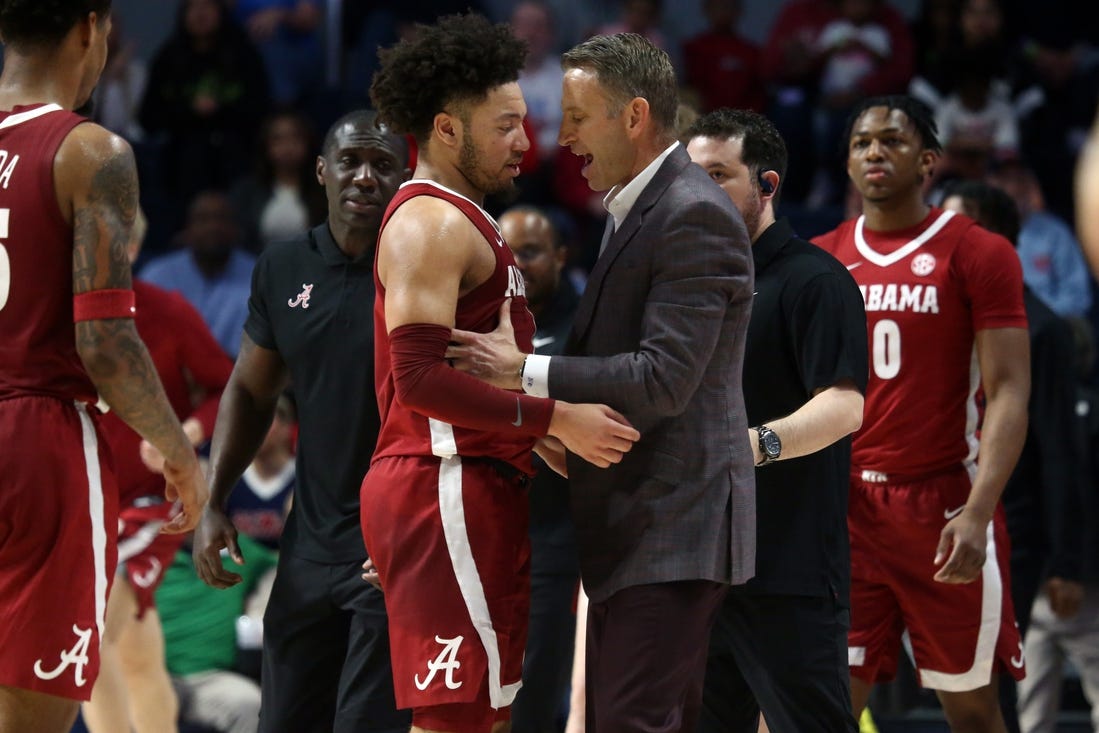 Feb 28, 2024; Oxford, Mississippi, USA; Alabama Crimson Tide head coach Nate Oats (right) embraces Alabama Crimson Tide guard Mark Sears (1) at the end of the first half against the Mississippi Rebels at The Sandy and John Black Pavilion at Ole Miss. Mandatory Credit: Petre Thomas-USA TODAY Sports