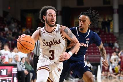 Feb 28, 2024; Chestnut Hill, Massachusetts, USA; Boston College Eagles guard Jaeden Zackery (3) drives the ball  against Virginia Cavaliers guard Dante Harris (1) during the second half at Conte Forum. Mandatory Credit: Eric Canha-USA TODAY Sports