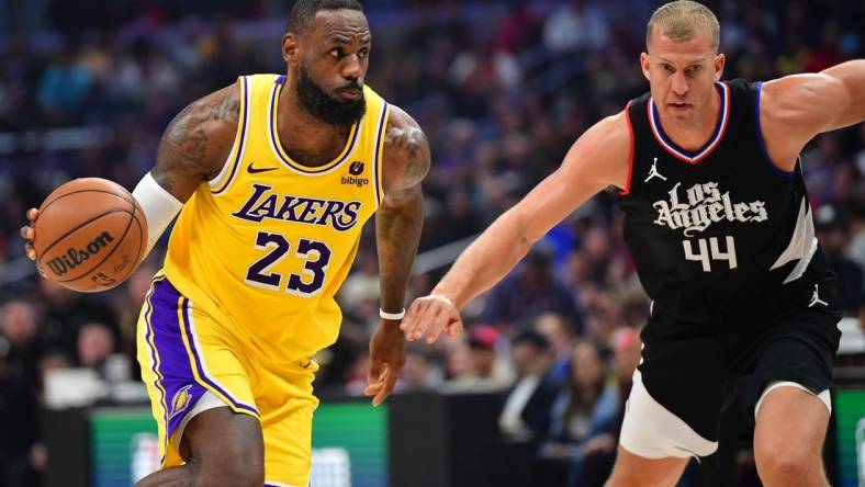 Feb 28, 2024; Los Angeles, California, USA; Los Angeles Lakers forward LeBron James (23) moves the ball against Los Angeles Clippers center Mason Plumlee (44) during the first half at Crypto.com Arena. Mandatory Credit: Gary A. Vasquez-USA TODAY Sports