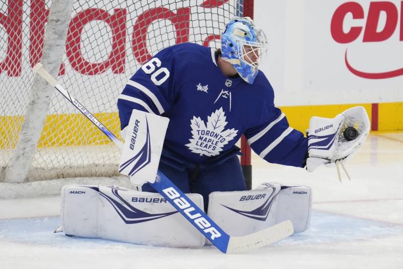 Feb 29, 2024; Toronto, Ontario, CAN; Toronto Maple Leafs goaltender Joseph Woll (60) makes a save during warm up before a game against the Arizona Coyotes at Scotiabank Arena. Mandatory Credit: John E. Sokolowski-USA TODAY Sports
