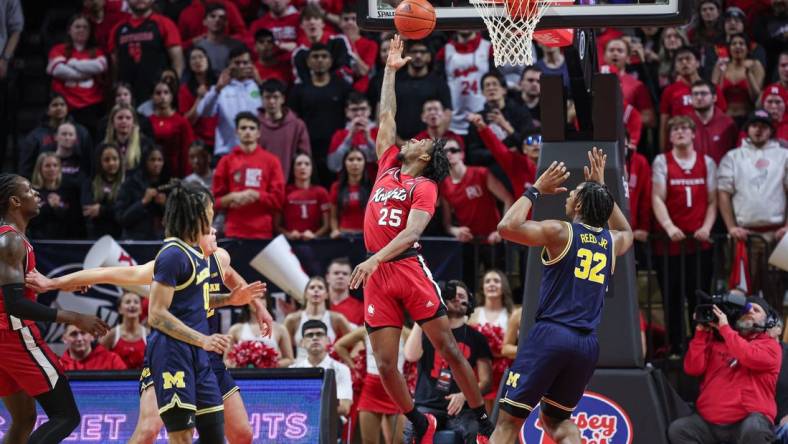 Feb 29, 2024; Piscataway, New Jersey, USA; Rutgers Scarlet Knights guard Jeremiah Williams (25) scores a basket in front of Michigan Wolverines forward Tarris Reed Jr. (32) during the first half at Jersey Mike's Arena. Mandatory Credit: Vincent Carchietta-USA TODAY Sports