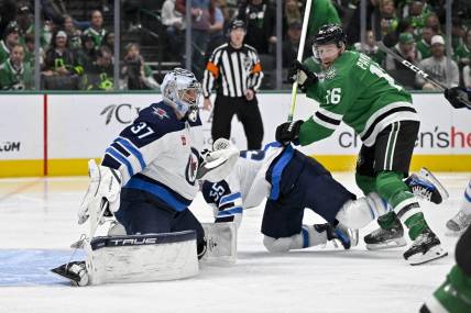 Feb 29, 2024; Dallas, Texas, USA; Dallas Stars center Joe Pavelski (16) checks Winnipeg Jets center Mark Scheifele (55) as goaltender Connor Hellebuyck (37) looks for the puck in the Jets zone during the second period at the American Airlines Center. Mandatory Credit: Jerome Miron-USA TODAY Sports
