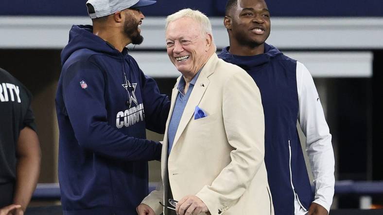 Aug 29, 2021; Arlington, Texas, USA; Dallas Cowboys quarterback Dak Prescott , owner Jerry Jones and receiver Amari Cooper talk prior to the game against the Jacksonville Jaguars at AT&T Stadium. Mandatory Credit: Matthew Emmons-USA TODAY Sports