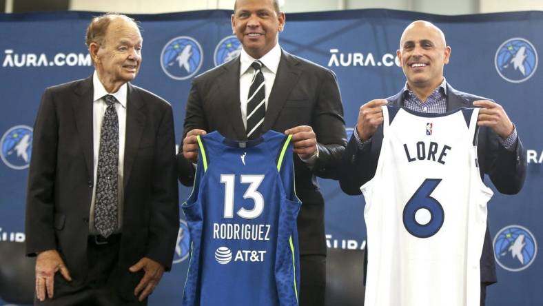 Sep 27, 2021; Minneapolis, MN, USA; Current owner Glen Taylor and limited partners and alt-governors for the Minnesota Timberwolves Alex Rodriguez and Mark Lore hold up jerseys after answering questions at a press conference at media day. Mandatory Credit: Bruce Kluckhohn-USA TODAY Sports