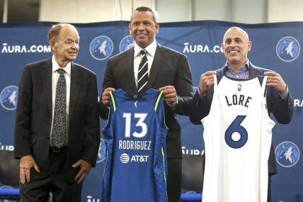 Sep 27, 2021; Minneapolis, MN, USA; Current owner Glen Taylor and limited partners and alt-governors for the Minnesota Timberwolves Alex Rodriguez and Mark Lore hold up jerseys after answering questions at a press conference at media day. Mandatory Credit: Bruce Kluckhohn-USA TODAY Sports