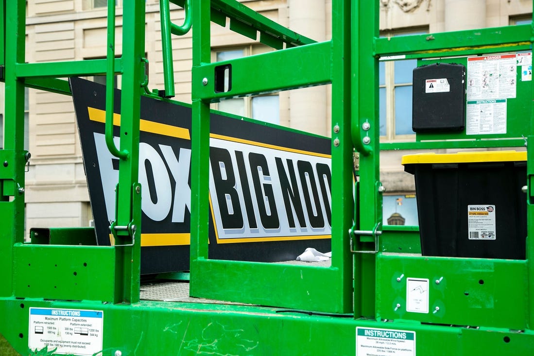 A Big Noon Kickoff logo is seen on a lift as setup continues for the Fox Sports NCAA football Big Noon Kickoff pregame show, Friday, Oct. 8, 2021, on the east side of the Pentacrest on the University of Iowa campus in Iowa City, Iowa.

211008 Big Noon Setup 007 Jpg