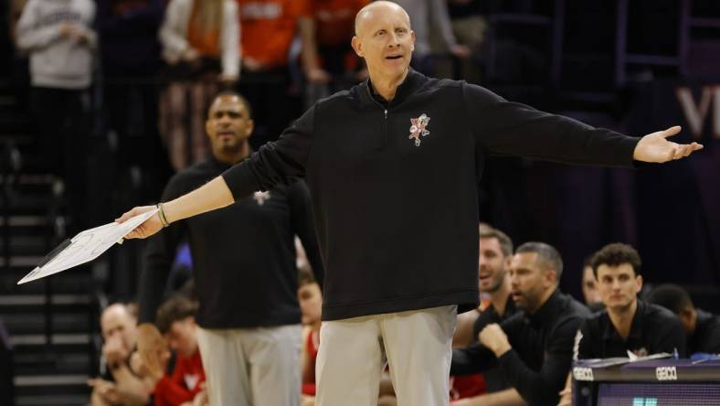 Jan 24, 2022; Charlottesville, Virginia, USA; Louisville Cardinals head coach Chris Mack gestures to a referee from the bench against the Virginia Cavaliers during the first half at John Paul Jones Arena. Mandatory Credit: Geoff Burke-USA TODAY Sports