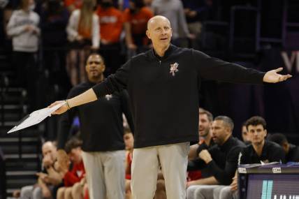 Jan 24, 2022; Charlottesville, Virginia, USA; Louisville Cardinals head coach Chris Mack gestures to a referee from the bench against the Virginia Cavaliers during the first half at John Paul Jones Arena. Mandatory Credit: Geoff Burke-USA TODAY Sports