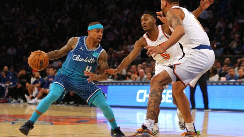 Mar 30, 2022; New York, New York, USA; Charlotte Hornets guard Isaiah Thomas (4) controls the ball against New York Knicks guard Immanuel Quickley (5) and forward Obi Toppin (1) during the second quarter at Madison Square Garden. Mandatory Credit: Brad Penner-USA TODAY Sports